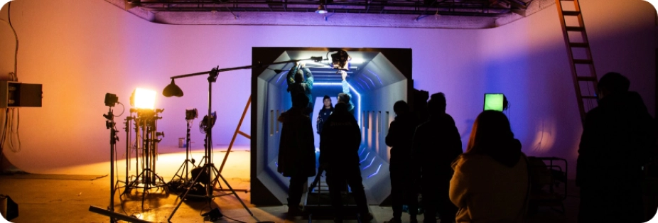 People gathered in front of a screen, with cameras working to make the best video for corporations.